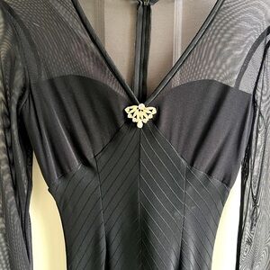 Long,J.McClintock,stretch,sheer ,cuffs accents. Gathered  base of spine.